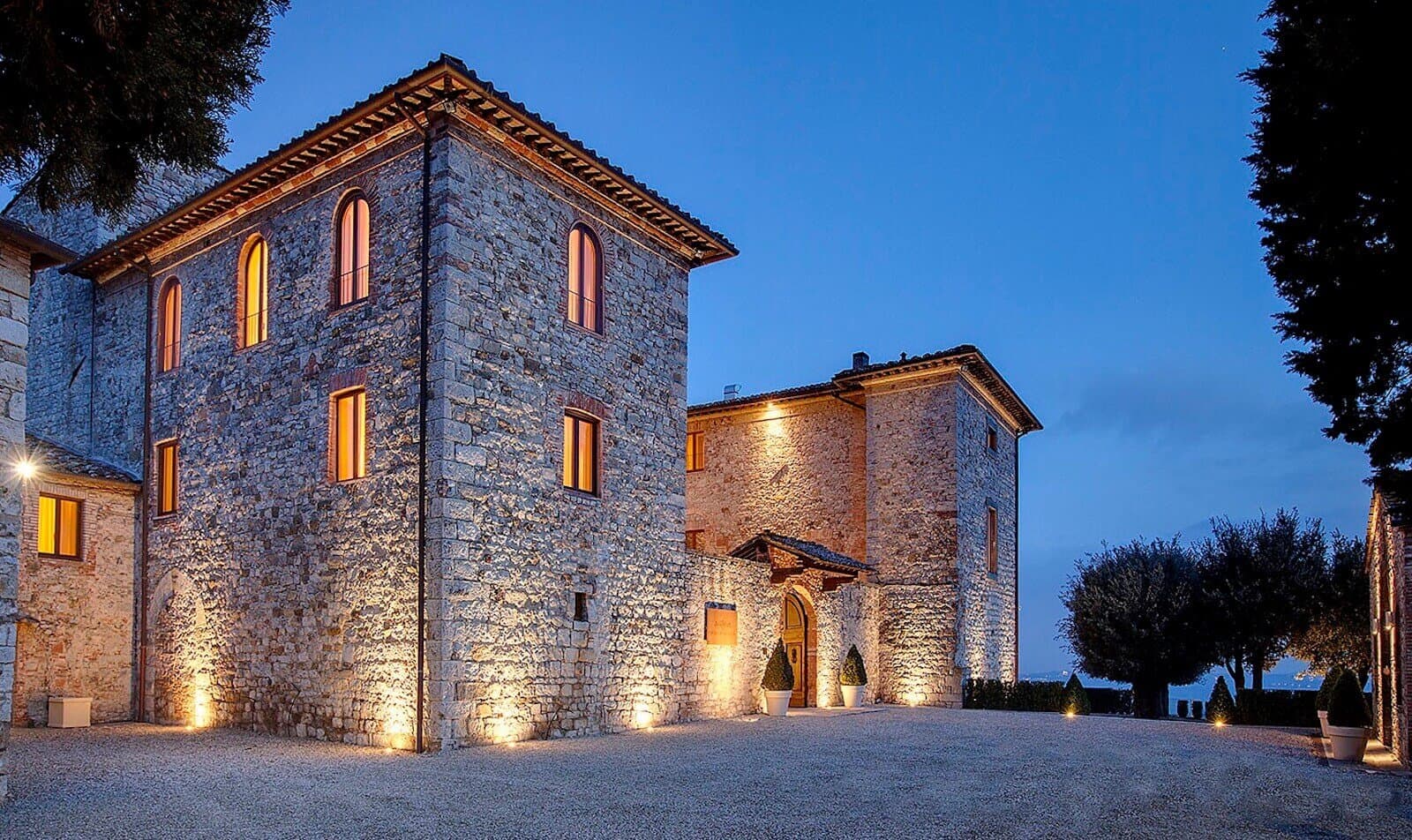 The stone towers of Castello La Leccia lit at dusk