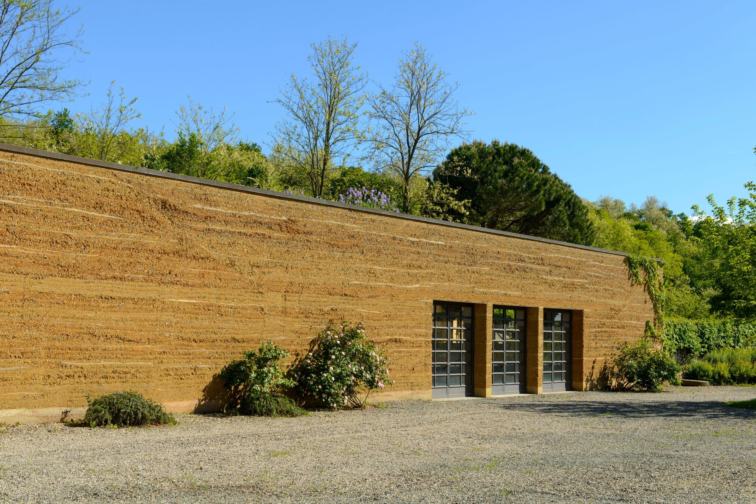 The long rammed-earth wall of the La Raia cellar